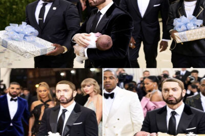 Eminem Breaks Hearts at Met Gala 2025 — Carries Grandson Down Red Carpet, But His Haunting Silence and Shocking Confession Leave Hollywood Speechless! At Met Gala 2025, Eminem stunned everyone—not with his outfit, but with his haunting silence. Holding his grandson tightly, he walked the red carpet with a blank, sorrowful expression, despite being greeted with gifts and admiration by stars like Beyoncé and Rihanna. The cameras loved him, but he barely smiled. When finally asked why he seemed so distant, Eminem gave a quiet answer that shocked the entire industry. It wasn’t about fame. It wasn’t about the glitz. It was something far more personal… and painful. What did he reveal? Why did he look so broken, even as the world celebrated him? The truth is heavier than anyone expected — and it’s just the beginning of a deeper, hidden story.