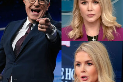 “She Wanted a Platform. He Gave Her a Mirror”.The studio lights were merciless, the kind that made every bead of sweat shine like a spotlight. Karoline Leavitt marched onto the stage with her lines sharpened and her smile rehearsed, ready to strike. And strike she did — words like d@ggers, accusations hurled with the swagger of someone who believed the night was already hers. The audience laughed nervously, waiting for Colbert to spar back…