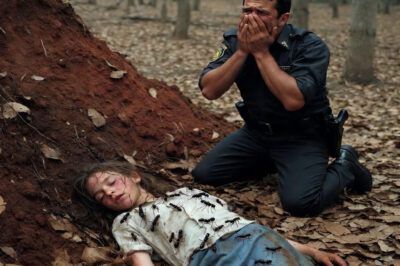 He found her covered in ants, half buried in the ground… and when the girl whispered a single word, the old policeman felt his chest split in two.