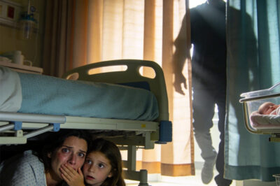 I had just given birth when my 8-year-old daughter came to visit me. She quietly closed the curtain and whispered, “Mom, get under the bed. Now.” We crawled underneath together, holding our breath. Then footsteps approached, and she gently covered my mouth.